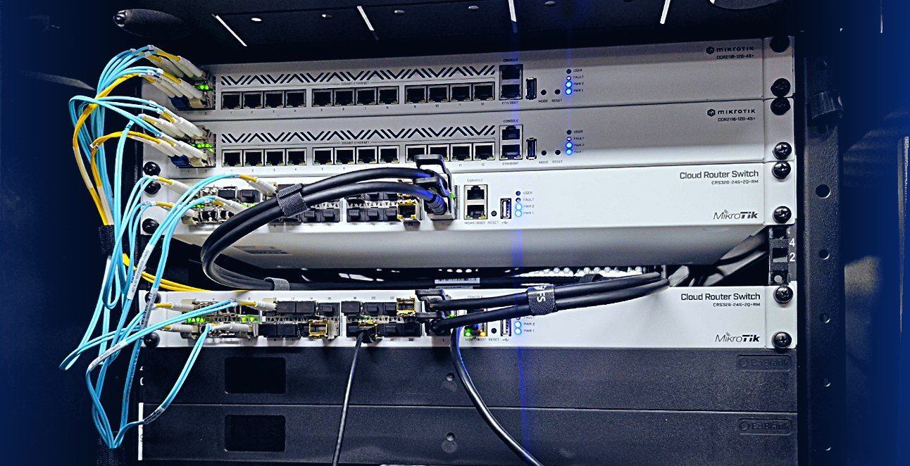 An AITS network rack at DigiCo Hawthorn with MikroTik routers and switches and fibre patching